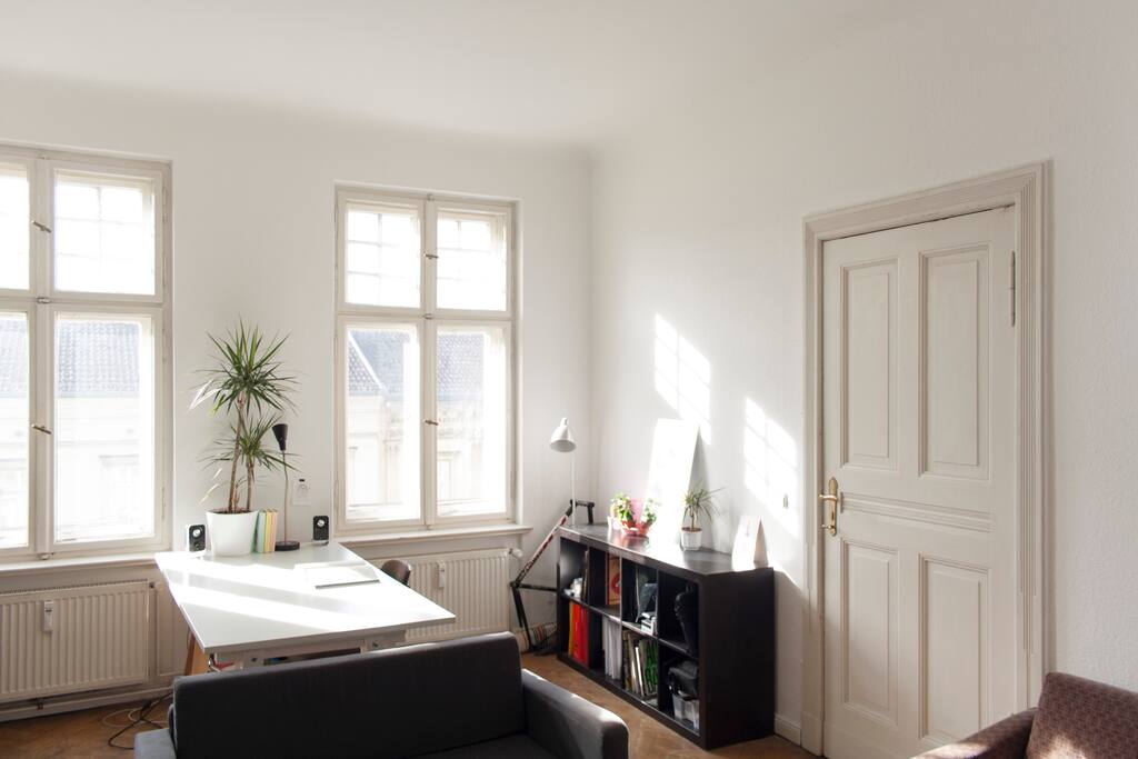 Sun bathed private living room with desk/workstation, chairs, sofa