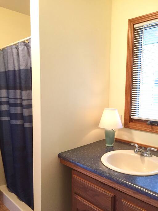 Full Bathroom off of kitchen. Shower is separate from bathroom/toilet area which is so nice when coming in off the beach or boating!