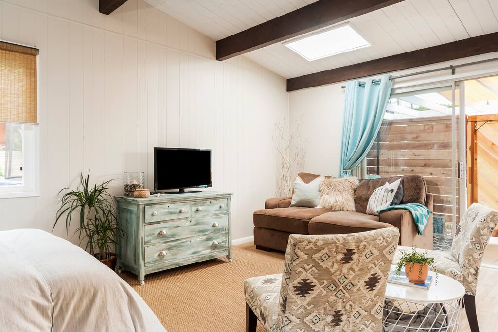 Open and airy floor plan with vaulted wood ceilings and a skylight that offers lots of natural light.