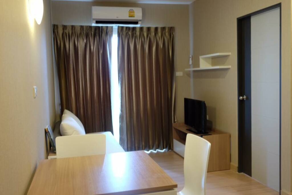 Space for work and relax: one desk, two chairs, one sofa, TV