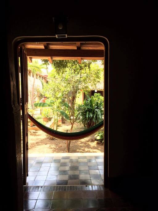 View from within the master bedroom out onto the garden and hammock on patio