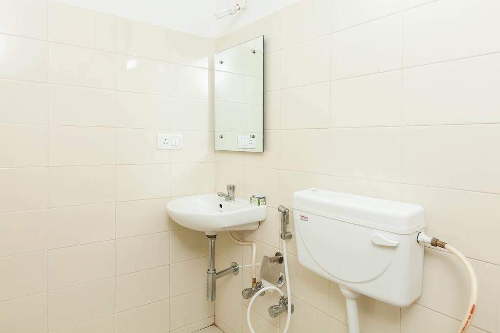 Clean bathroom with wash basin and toilet.