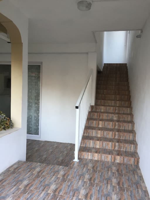Stairs leading to first floor apartment