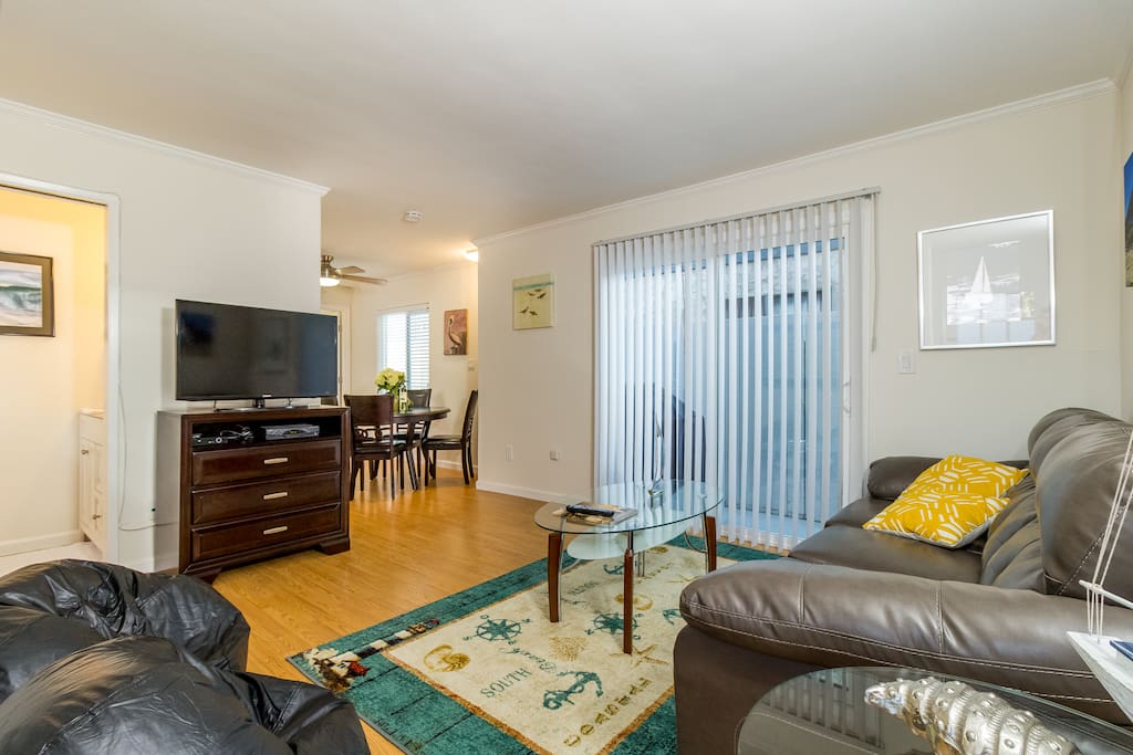 Living Room: Large flat screen TV with cable and dvd player. Half Bath on the left and open to the dining/kitchen