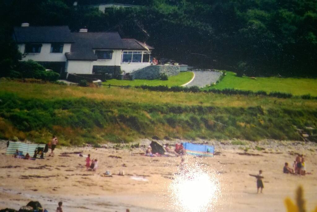 Wider view of house showing location and beach
