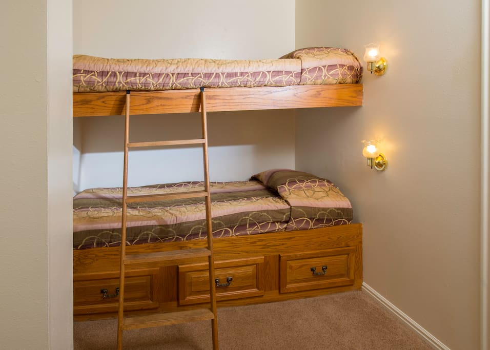 Bunk beds are located in a small loft area at the top of the stairs, near the master bedroom.
