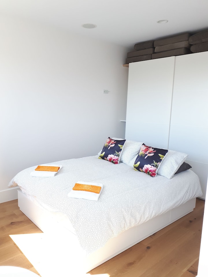 غرفة نوم رئيسية مشمسة للغاية... تحتوي على سرير بحجم كوين مع تخزين تحت السرير وخزانة ملابس. تتسع غرفة النوم الرئيسية هذه في الطابق العلوي لنوم شخصين.