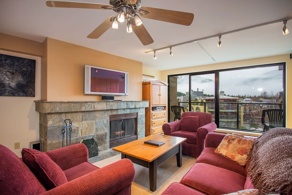 The living room features a stunning stone wood burning fireplace.