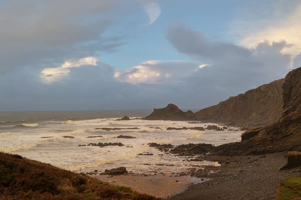 Looking north to "Cow and Calf" on southwest coast path near cottage and Hartland Point.