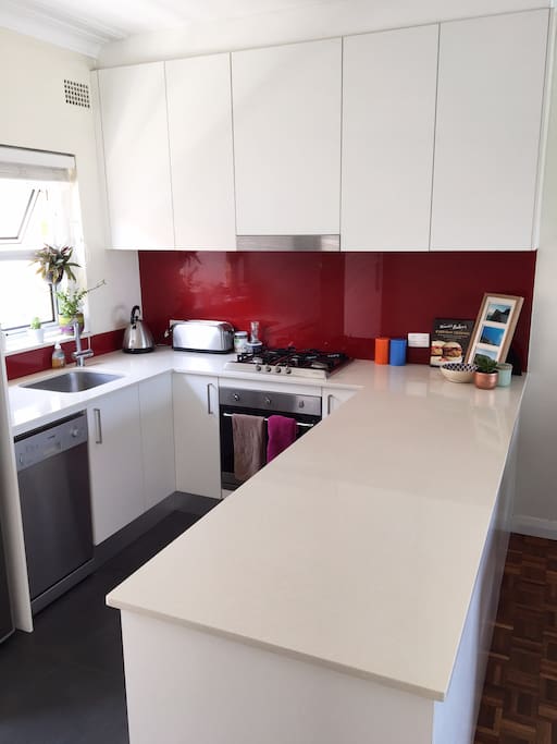 Contemporary kitchen with lots of space for cooking & chatting to guests