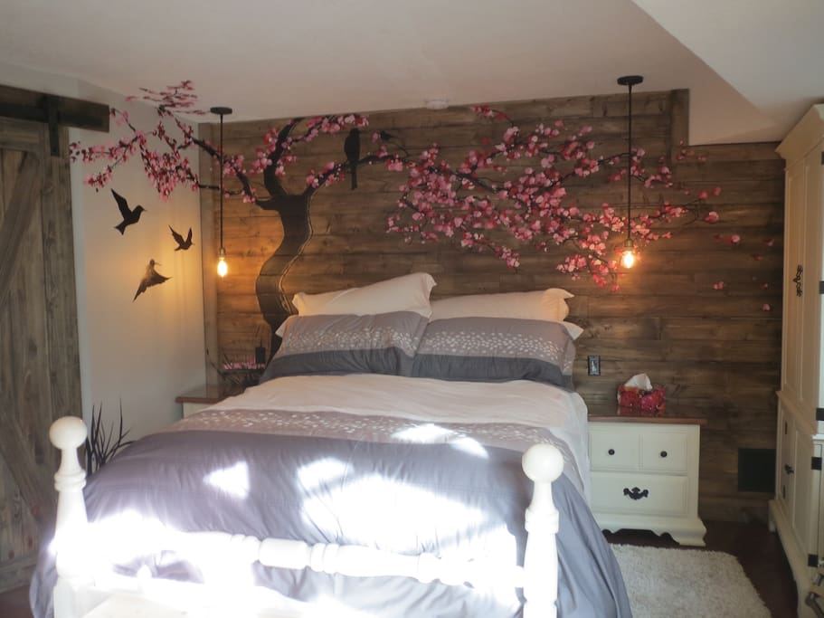 A beautiful hand painted cherry tree mural framing your own queen bed.