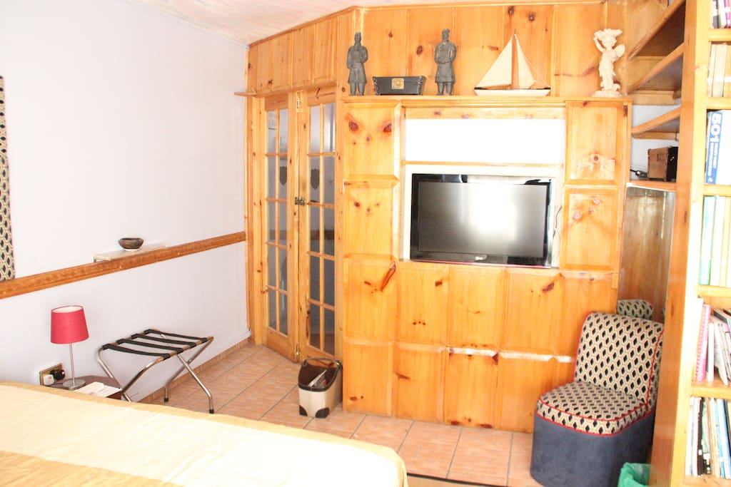 Flat Screen TV area leading to Living room and Kitchen