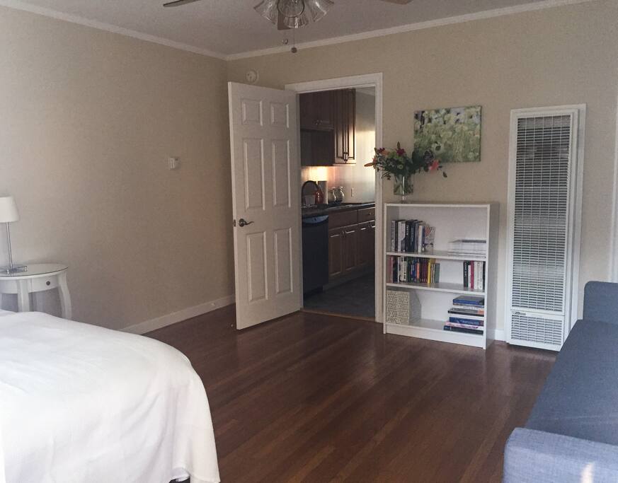 The main room has two doors to access other parts of the property. Door shown here accesses the kitchen. Main room is furnished with a queen-size bed and a sleeper sofa that easily converts into a bed.