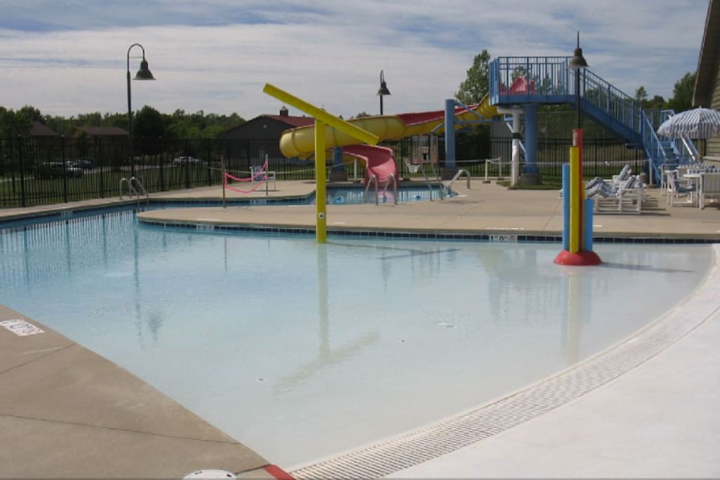 Outdoor heated pool with big water slide, and water fountains