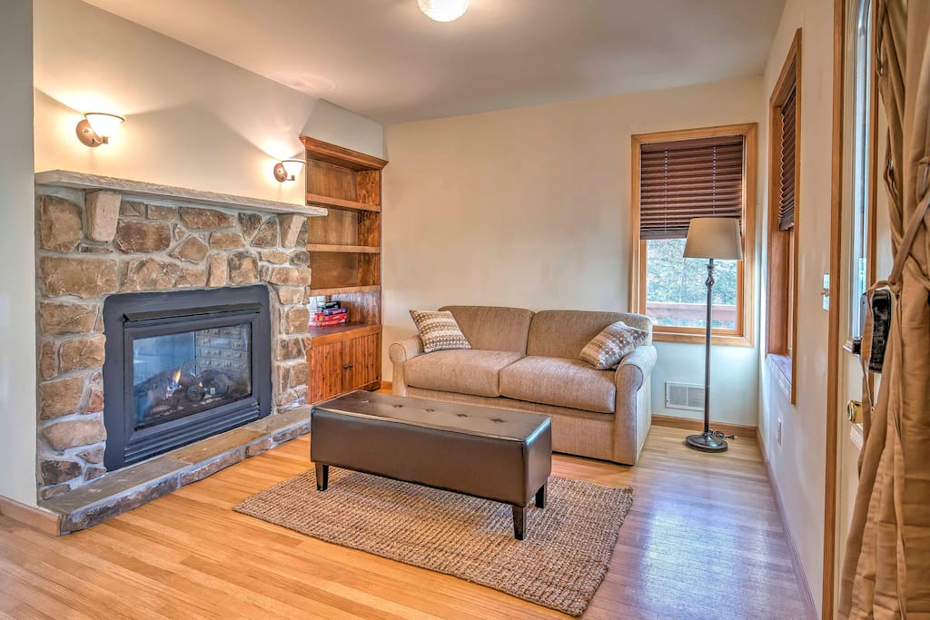 The double-sided stone gas-burning fireplace creates a warm and inviting feel throughout.