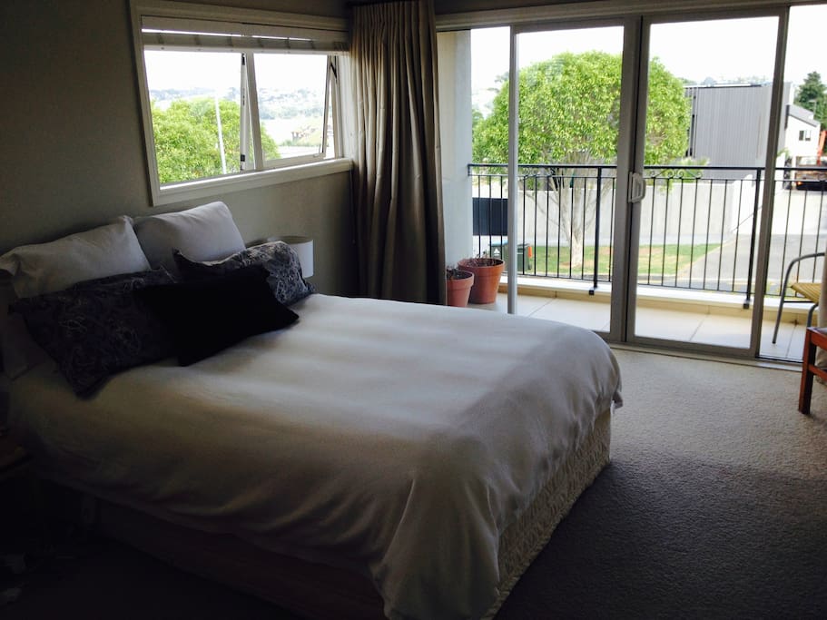The spacious bedroom has lovely views over the water to the harbour and Cornwall Park.