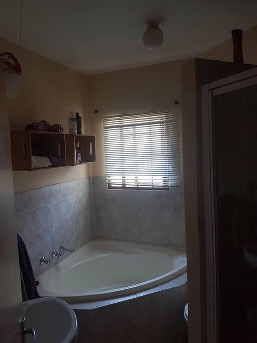 Second bathroom with corner bath and shower