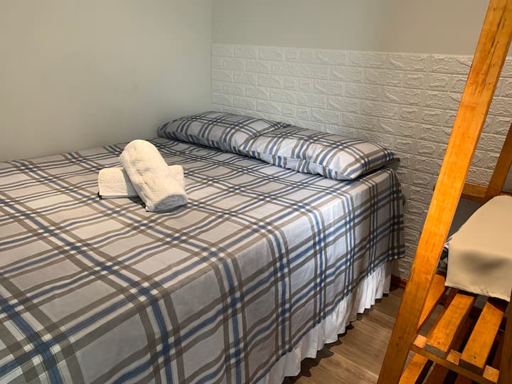 Double Box Bed with fresh bedding and fresh towels, Powerful Air Conditioning, Smart TV for relaxing watching a series, blackout curtain for that nap until later and a clothing rack.