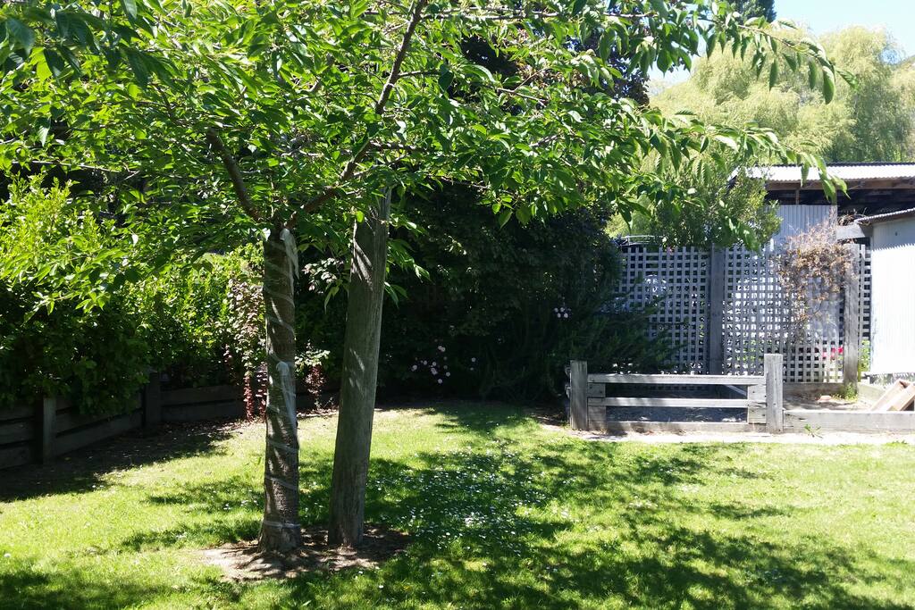 Lovely back yard with sandpit and playground for kids.