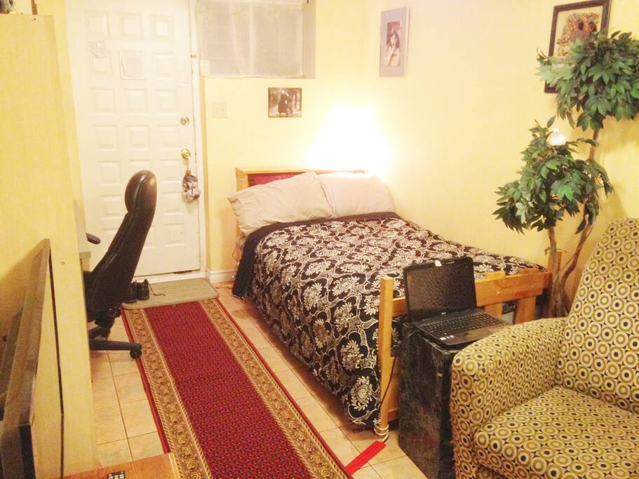 One of three single beds in this room. This one is beside the entrance.
