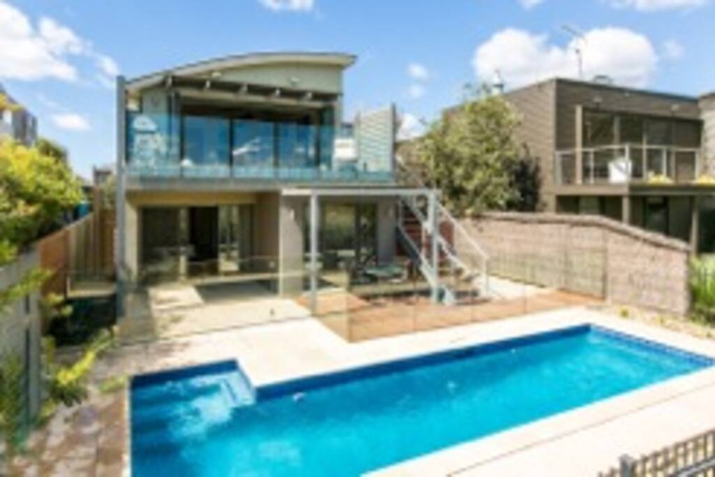 Rear of house with balcony and Webber BBQ and outdoor timber table to take in the beautiful golf course views of three fare ways and the lake that has swans and ducks.