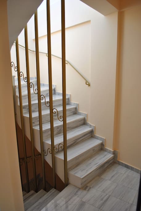Marble stairs leading to second floor and roof for washer and dryer.