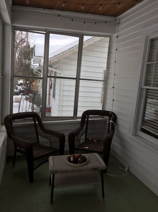Enclosed front porch with lots of seating.