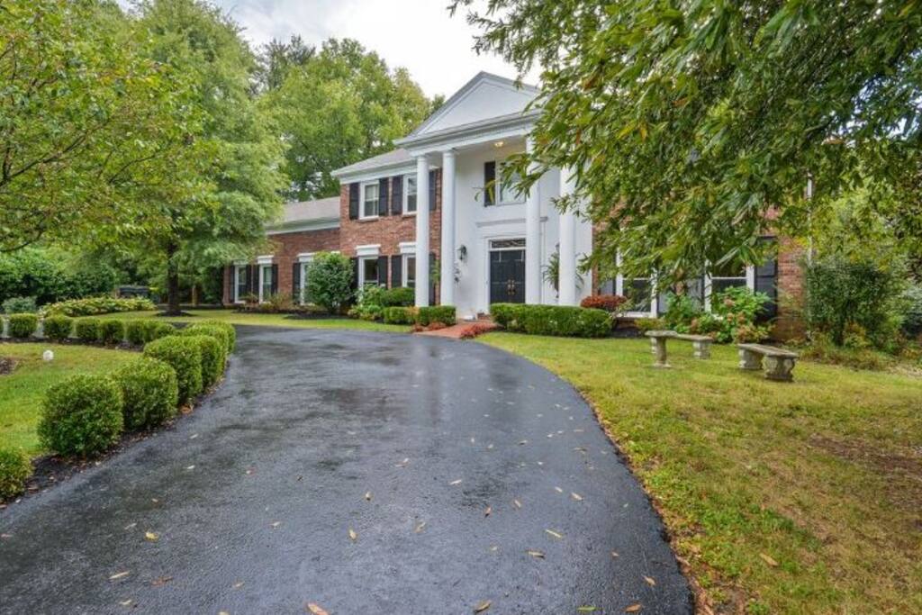 Circular driveway with 2 car garage around back w/additional parking for 4 cars