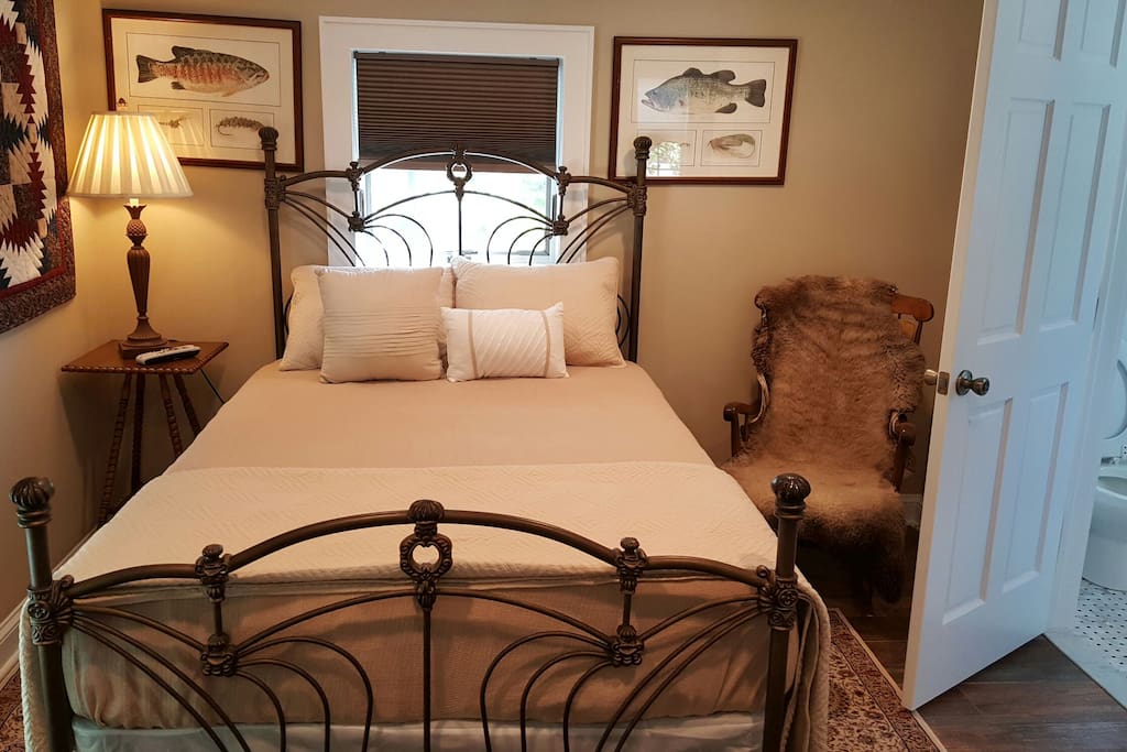 The master bedroom with a view of the bathroom on the right. Hanging on the wall is a handmade quilt.