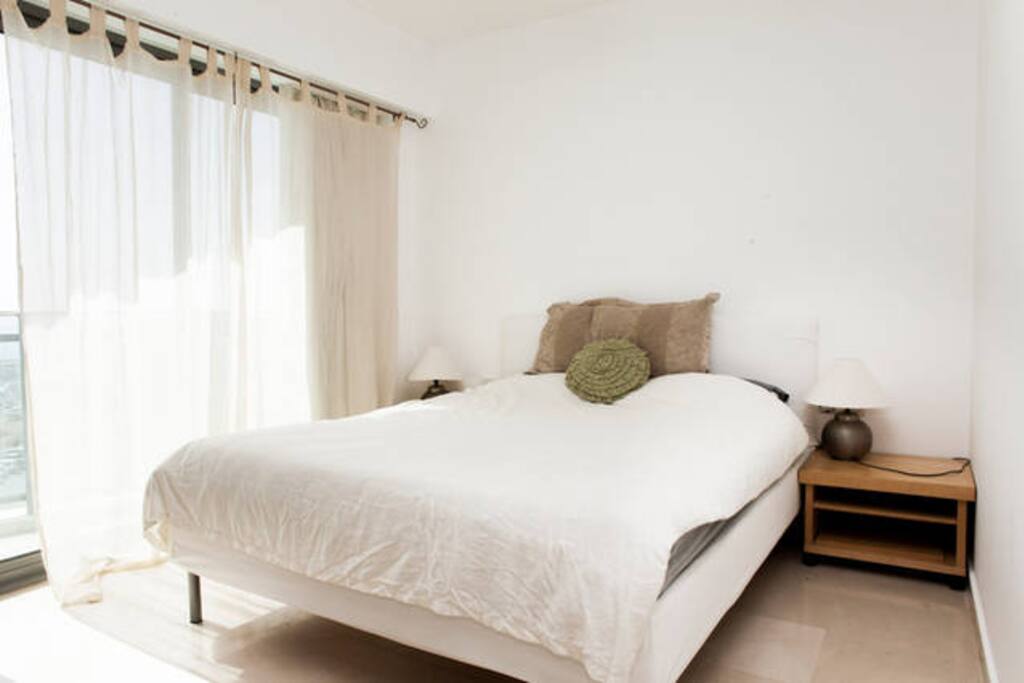 Bedroom with an exit to a modest balcony