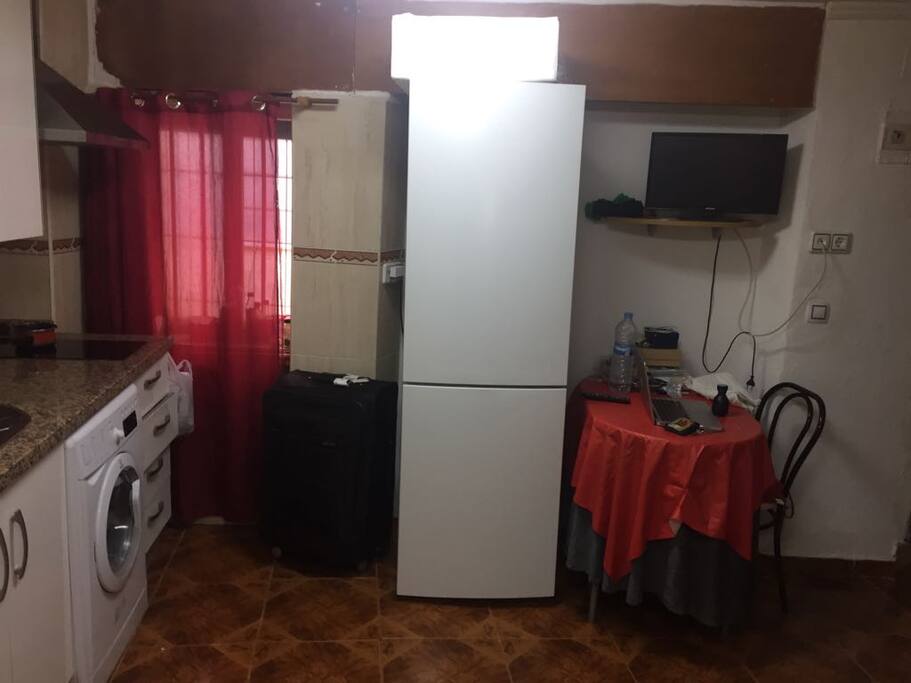 Cocina con Frigorífico, Comedor, TV, Lavadora y Microondas.