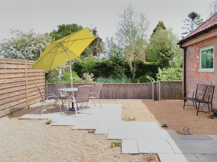 The rear garden overlooks the pond and has space for eating out, including a BBQ