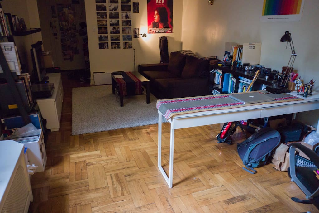 Another perspective on the living room. There is a small desk that looks out onto the street.