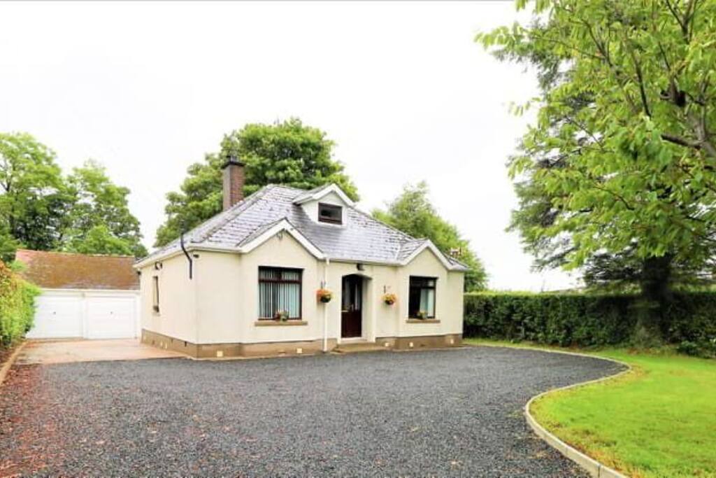Front of Killead Cottage with private driveway, turning and parking space for several cars.
