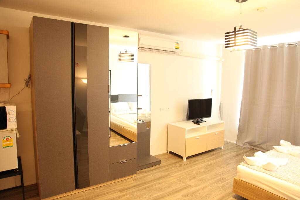 Tv,dressing table and a wardrobe.