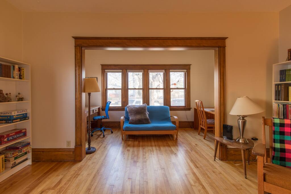 This is the view toward the street, looking across the living room. Most of the apartment features hardwood floors.
