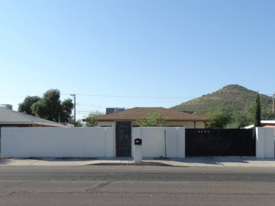 Security wall with locking walk through gate, along with rolling gate to park 2 vehicles inside