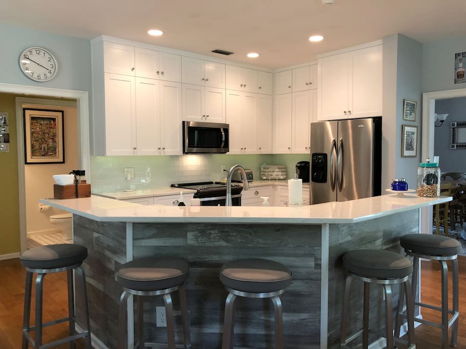 Newly renovated eat in kitchen with 5 barstools