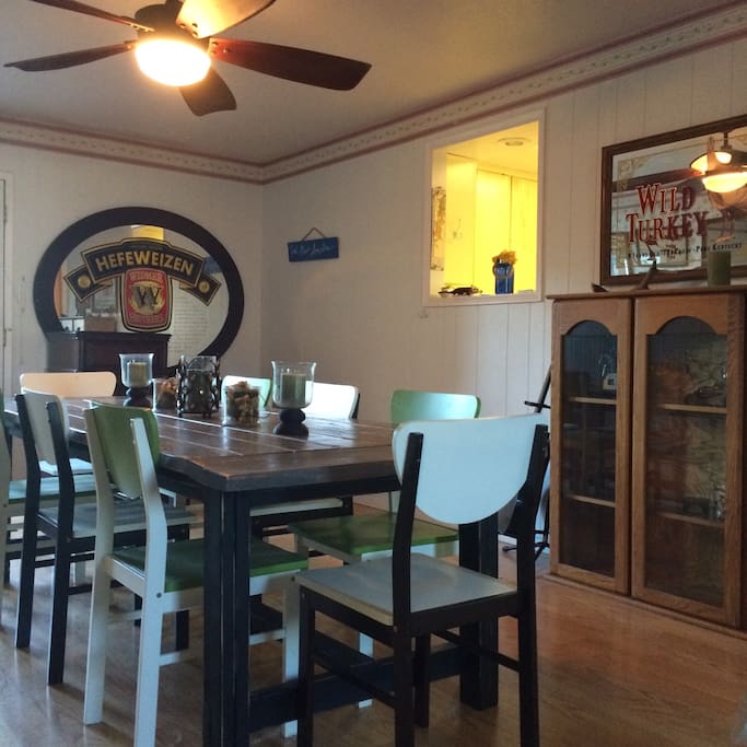 Large barn style table comfortably seats eight. Convenient pass through window between kitchen and dining room.