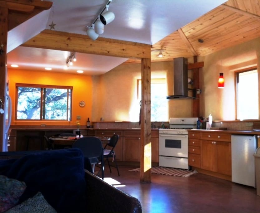 Large open kitchen with solar heated floor. Desk area with view.