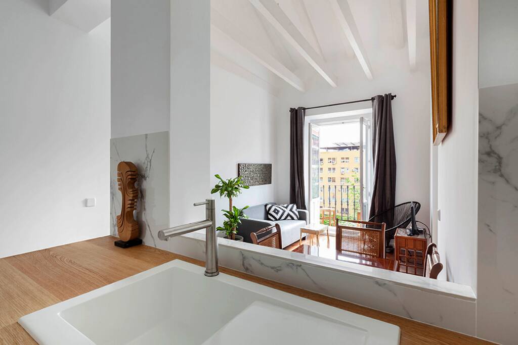 Open plan kitchen through to living area and balcony.
