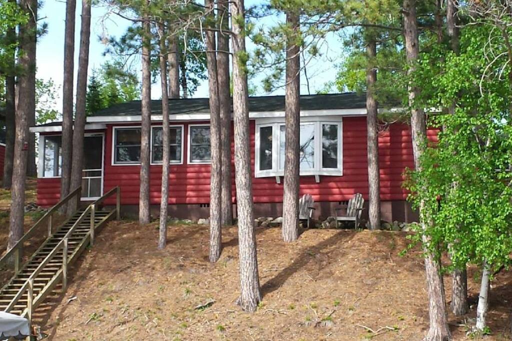 View from waters edge, screen porch with seating; bay window in family room