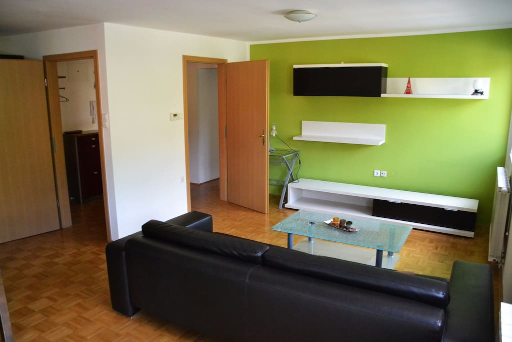Living room has plenty of space and sunlight.