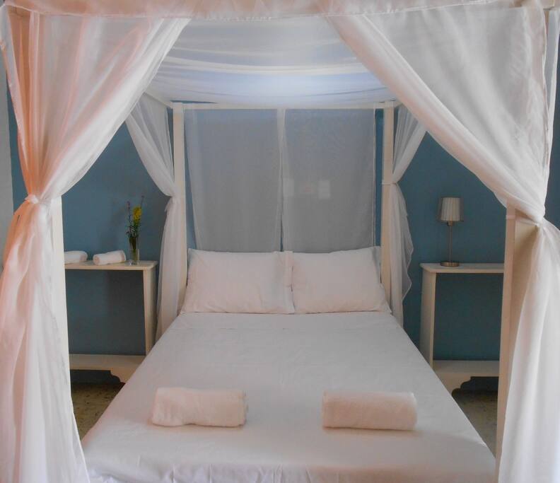 Habitación con cama matrimonial y vistas al jardín