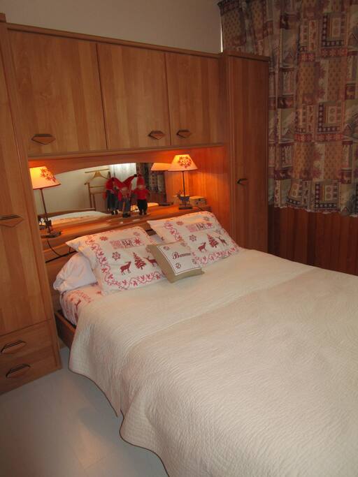 Après une bonne journée intense, vous apprécierez un repos bien mérité dans cette chambre chaleureuse à l'esprit montagne avec vue sur les chalets enneigés.