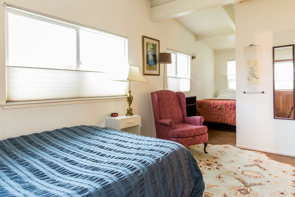 Double bed in far alcove of master bedroom
