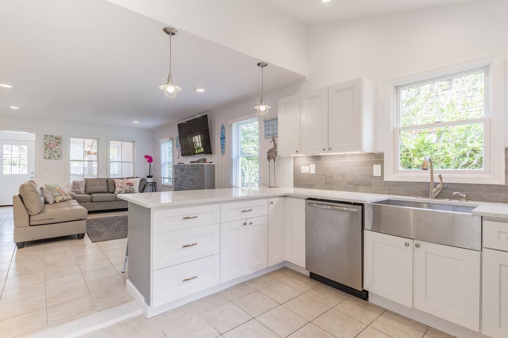 This luxurious beach home has everything you need for a relaxing getaway with this bright kitchen, amazing living room, and spa bathrooms!
