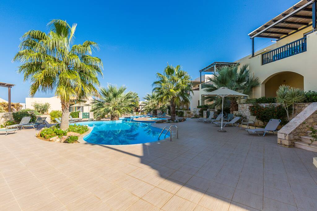 The pool area is equipped with sun beds, umbrellas and an outdoor shower!