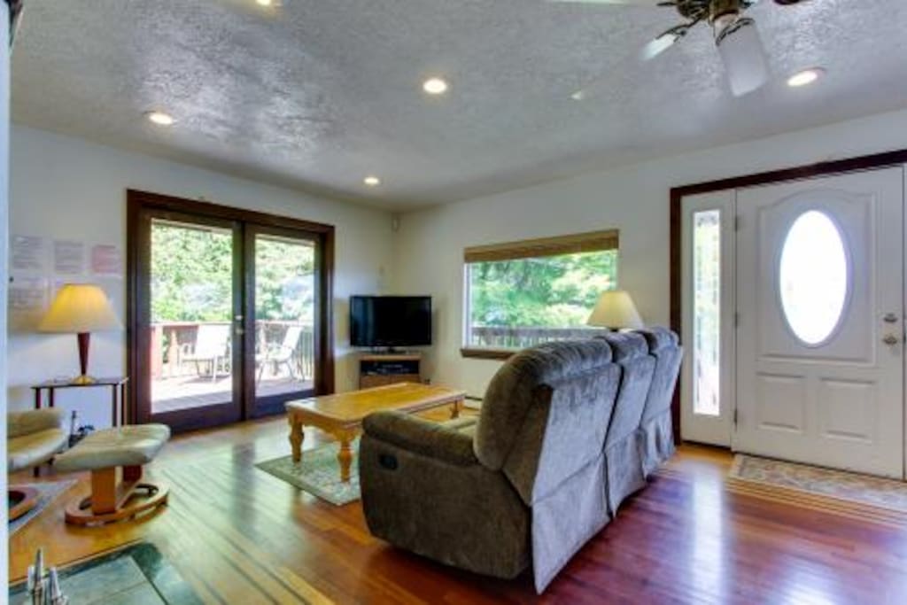 Living room with french doors to the deck, barbecue and hot-tub.
