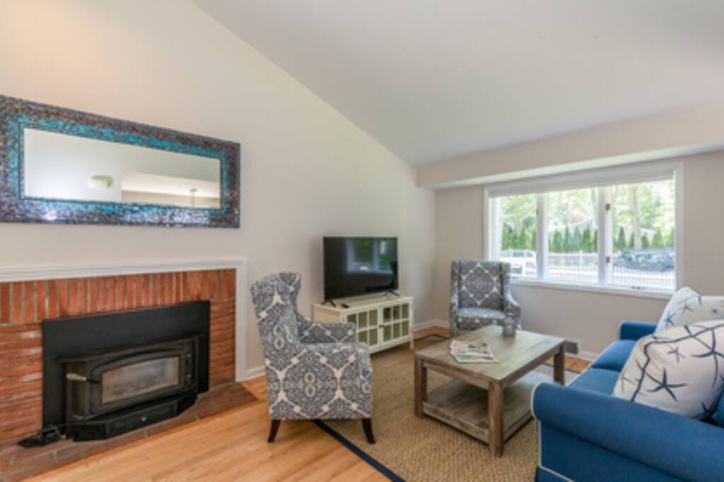 Living room and 1 of 3 televisions.